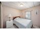 Comfortable bedroom with side table, lamp and window providing natural lighting at 1005 45Th E Ave, Ellenton, FL 34222