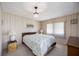 Cozy bedroom featuring a chandelier, wallpaper and a comfortable bed with side tables at 1005 45Th E Ave, Ellenton, FL 34222