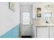 Bright kitchen with wainscoting, white cabinets, and modern appliances near a back door at 1005 45Th E Ave, Ellenton, FL 34222