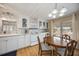 Open kitchen with white appliances, dining area, and updated countertops; ideal for entertaining at 1005 45Th E Ave, Ellenton, FL 34222