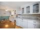 Charming kitchen adjacent to a dining area with white cabinets and modern appliances at 1005 45Th E Ave, Ellenton, FL 34222