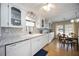 Well-lit kitchen featuring white cabinets, granite countertops, modern appliances, and adjacent dining area at 1005 45Th E Ave, Ellenton, FL 34222