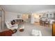 Spacious living room featuring a comfortable seating area, neutral decor, and adjacent kitchen and dining spaces at 1005 45Th E Ave, Ellenton, FL 34222