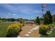Picturesque park view at Forever Veterans Park, featuring a bench, flag, and serene lake backdrop at 1005 45Th E Ave, Ellenton, FL 34222