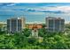 Stunning aerial view of beachfront condos with manicured grounds and direct access to a beautiful sandy beach at 1241 Gulf Of Mexico Dr # 803, Longboat Key, FL 34228
