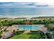 Expansive outdoor area featuring a pool, lush green grass, seating areas, and ocean views at 1241 Gulf Of Mexico Dr # 803, Longboat Key, FL 34228