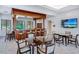Community bar area featuring dark wood, bar seating, tables, and a television at 1241 Gulf Of Mexico Dr # 803, Longboat Key, FL 34228