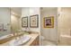 Stylish bathroom with a marble vanity, an oval sink, a large mirror, and a glass shower at 1241 Gulf Of Mexico Dr # 803, Longboat Key, FL 34228
