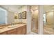 Elegant bathroom showcasing a marble vanity, a large mirror, and a glass-enclosed shower with tile accents at 1241 Gulf Of Mexico Dr # 803, Longboat Key, FL 34228