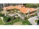 Stunning building with a terracotta tile roof, lush landscaping, and an inviting entrance at 1241 Gulf Of Mexico Dr # 803, Longboat Key, FL 34228