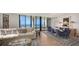 Bright living room featuring hardwood floors, modern furniture, and expansive ocean views through large windows at 1241 Gulf Of Mexico Dr # 803, Longboat Key, FL 34228