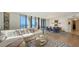 Bright living room featuring hardwood floors, modern furniture, and expansive ocean views through large windows at 1241 Gulf Of Mexico Dr # 803, Longboat Key, FL 34228