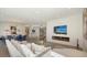 Open-concept living space with a modern fireplace, TV, and ocean views, perfect for relaxing and entertaining at 1241 Gulf Of Mexico Dr # 803, Longboat Key, FL 34228