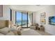 The main bedroom features comfortable seating and glass doors with a waterfront balcony at 1241 Gulf Of Mexico Dr # 803, Longboat Key, FL 34228