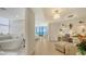 This main bedroom has access to a soaking tub and a built in desk with shelving at 1241 Gulf Of Mexico Dr # 803, Longboat Key, FL 34228