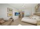 A spacious main bedroom features art work, television and bright natural lighting at 1241 Gulf Of Mexico Dr # 803, Longboat Key, FL 34228