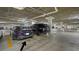 Well-lit parking garage with luxury vehicles parked in designated spots at 1241 Gulf Of Mexico Dr # 803, Longboat Key, FL 34228