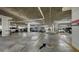 Well-lit parking garage with clearly marked parking spots and visible structural elements at 1241 Gulf Of Mexico Dr # 803, Longboat Key, FL 34228