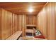Community sauna room with wood paneling, benches, and sauna rocks at 1241 Gulf Of Mexico Dr # 803, Longboat Key, FL 34228