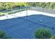 Aerial view of community tennis courts surrounded by lush landscaping at 1241 Gulf Of Mexico Dr # 803, Longboat Key, FL 34228