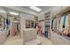 This walk in closet has custom cabinetry and lots of storage space at 1241 Gulf Of Mexico Dr # 803, Longboat Key, FL 34228