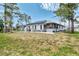 Exterior shot of a house with solar panels on a large lot with green grass at 1271 Nantucket Rd, Venice, FL 34293