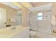 Well-lit bathroom with a shower/tub combo, frosted glass door, and white fixtures at 1271 Nantucket Rd, Venice, FL 34293