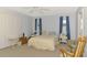 Bedroom featuring carpet flooring, two windows, ceiling fan, and a rocking chair at 1271 Nantucket Rd, Venice, FL 34293