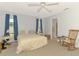 Bedroom featuring carpet flooring, two windows, ceiling fan, and a rocking chair at 1271 Nantucket Rd, Venice, FL 34293