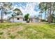 Single story home with a large front yard, an attached garage, and a white exterior at 1271 Nantucket Rd, Venice, FL 34293