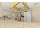 Bright kitchen featuring tile countertops, white appliances, and ample cabinet space at 1271 Nantucket Rd, Venice, FL 34293
