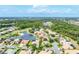 A beautiful aerial view of a residential neighborhood that is built around a small lake and golf course at 1311 Tuscany Blvd, Venice, FL 34292