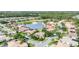 An aerial view of a beautiful residential neighborhood with mature landscaping and beautiful barrel tile roofs at 1311 Tuscany Blvd, Venice, FL 34292