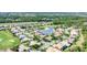 Beautiful aerial view of a residential neighborhood that is built around a small lake and golf course at 1311 Tuscany Blvd, Venice, FL 34292