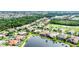 Expansive aerial view showcasing the community's homes, lush landscaping, and serene waterfront features at 1311 Tuscany Blvd, Venice, FL 34292