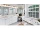 Bright bathroom featuring double sinks, soaking tub, vanity, and large mirror at 1311 Tuscany Blvd, Venice, FL 34292