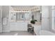 Bright bathroom featuring double sinks, soaking tub, vanity, and large mirror at 1311 Tuscany Blvd, Venice, FL 34292
