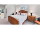 Cozy primary bedroom with wood furnishings and ample natural light at 1311 Tuscany Blvd, Venice, FL 34292