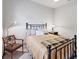 Neutral bedroom featuring a comfortable bed, stylish side table, and large window at 1311 Tuscany Blvd, Venice, FL 34292