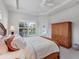 Light filled bedroom has a beautiful ceiling and view of outdoors at 1311 Tuscany Blvd, Venice, FL 34292