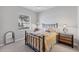 Neutral bedroom featuring a comfortable bed, stylish side table, and large window at 1311 Tuscany Blvd, Venice, FL 34292
