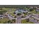 Stunning aerial view of clubhouse, landscaped grounds, and ample parking at 1311 Tuscany Blvd, Venice, FL 34292