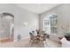 Cozy dining area with large arched window, stylish seating, and ample natural light at 1311 Tuscany Blvd, Venice, FL 34292