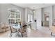 Bright dining area featuring a glass-top table, arched windows, and neutral decor at 1311 Tuscany Blvd, Venice, FL 34292
