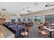 Well lit dining room with golf course views, neutral colors, and ample seating at 1311 Tuscany Blvd, Venice, FL 34292