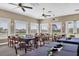 Well lit dining room with golf course views, neutral colors, and seating for large groups at 1311 Tuscany Blvd, Venice, FL 34292