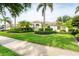 Beautiful single Gathering home featuring a manicured lawn and mature landscaping at 1311 Tuscany Blvd, Venice, FL 34292
