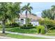 Charming single-Gathering home showcasing a manicured lawn and lush, mature landscaping at 1311 Tuscany Blvd, Venice, FL 34292