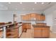 Well-lit kitchen featuring a breakfast bar, central island, and functional layout at 1311 Tuscany Blvd, Venice, FL 34292