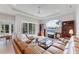 Well-lit living room with comfortable furniture and access to the outdoor patio at 1311 Tuscany Blvd, Venice, FL 34292